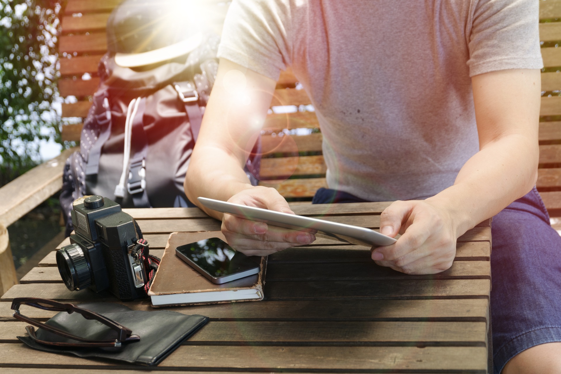 Man traveler is reading electronic book on tablet , while is relaxing in the cafe , with light morning ,travel and recreation concept